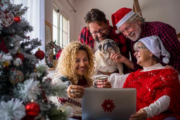 Family with dog attending video call through laptop at home model released Symbolfoto property released SIPF02432