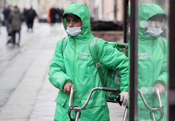 MOSCOW, RUSSIA - OCTOBER 24, 2021: A Delivery Club food delivery service employee is seen in central Moscow. Moscow and Moscow Region have declared non-working days from October 28 to November 7 to prevent the spread of the novel coronavirus. Cafes, restaurants, shopping malls and non-food shops will be closed in these days. School students will go on vacation. Alexander Shcherbak TASS  TS1157BE