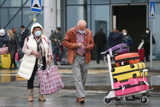 CRIMEA, RUSSIA - OCTOBER 24, 2021: Passengers seen outside Simferopol International Airport. Non-working days have been declared in Crimea from October 30 to November 7, the respective presidential decree coming as a response to the rising number of COVID-19 cases in Russia. The Crimean authorities plan to enhance enforcement of public health safety measures at local holiday resorts within this period. Russia s Deputy Prime Minister Tatyana Golikova called on citizens to refrain from travelling between regions so as not to further complicate the existing coronavirus situation. Sergei Malgavko TASS  TS1157E1