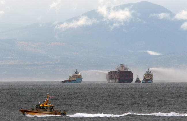 October 24, 2021, Victoria, BC, Canada: Ships work to control a fire onboard the MV Zim Kingston about eight kilometres from the shore in Victoria, B.C., on Sunday, October 24, 2021. The container ship caught fire on Saturday and 16 crew members were evacuated and brought to Ogden Point Pier. Victoria Canada  - ZUMAc35_ 20211024_zaf_c35_002 Copyright: xChadxHipolitox