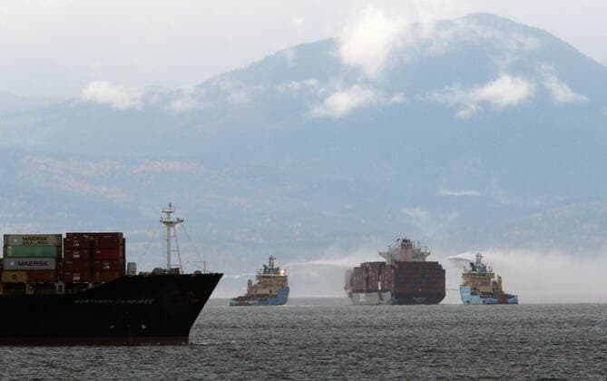 October 24, 2021, Victoria, BC, Canada: Ships work to control a fire onboard the MV Zim Kingston about eight kilometres from the shore in Victoria, B.C., on Sunday, October 24, 2021. The container ship caught fire on Saturday and 16 crew members were evacuated and brought to Ogden Point Pier. Victoria Canada  - ZUMAc35_ 20211024_zaf_c35_001 Copyright: xChadxHipolitox