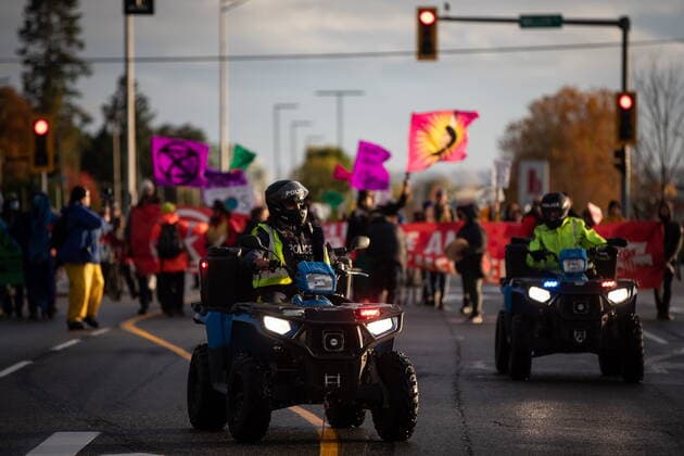 October 25, 2021, Richmond, BC, Canada: RCMP officers on all terrain vehicles lead the environmental activist group Extinction Rebellion as they march before blocking the main road used to access Vancouver International Airport, in Richmond, B.C., Monday, Oct. 25, 2021. More than a dozen people were arrested and traffic to and from the airport was diverted due to the protest which was part of the group s two week October Rebellion action. Richmond Canada  - ZUMAc35_ 20211025_zaf_c35_144 Copyright: xDarrylxDyckx
