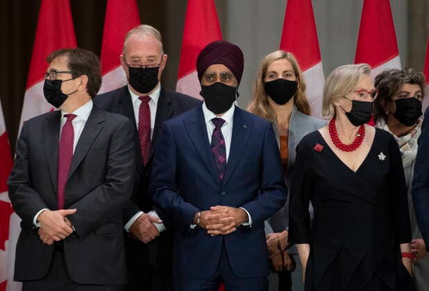 October 26, 2021, Ottawa, ON, CAN: Minister of Natural Resources Jonathan Wilkinson, Minister of International Development and Minister responsible for the Pacific Economic Development Agency of Canada Harjit Sajjan and Minister of Mental Health and Addictions and Associate Minister of Health Carolyn Bennett, who all saw their ministerial positions shuffled, wait for Prime Minister Justin Trudeau to arrive at a news conference after the federal cabinet was sworn in, in Ottawa, on Tuesday, Oct. 26, 2021. Ottawa CAN - ZUMAc35_ 20211026_zaf_c35_239 Copyright: xJustinxTangx