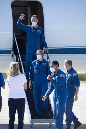 ESA Astronaut Matthias Maurer waves as he arrives at the Kennedy Space Center, Florida with his Crew-3 mates Kayla Barron, Tom Marshburn and Raja Chari (back to front) on Tuesday, October 26, 2021. The crew is scheduled to launch on a mission to the International Space Station on Oct 31.  KSP20211026011 JOExMARINO