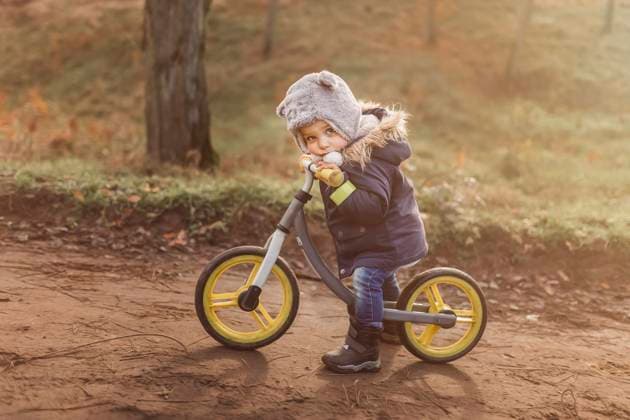 IMAGO Creative: Fit durch den Herbst Small tired boy in forest sitting on his push bike with yellow w Gryfino, West Pomeranian Voivodeship, Poland CR_XCKH211020-853176-01 ,model released, Symbolfoto