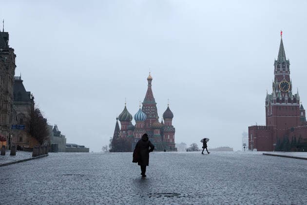 MOSCOW, RUSSIA - OCTOBER 28, 2021: A woman crosses the deserted Red Square. A recent surge in COVID-19 cases in Russia has prompted the Moscow authorities to declare non-working days with pay from October 28 to November 7. Sergei Bobylev TASS  TS1160A4
