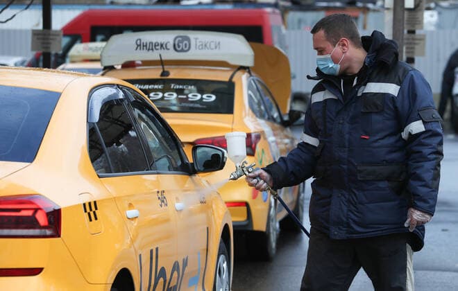 MOSCOW, RUSSIA - OCTOBER 28, 2021: A driver carries out disinfection of an Uber taxi amid the ongoing COVID-19 pandemic. Sergei Karpukhin TASS  TS1161F1