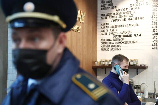 MOSCOW, RUSSIA - OCTOBER 29, 2021: An officer of Moscow s Association of Administrative and Technical Inspections checks compliance with sanitary and public health safety requirements at a cafe at the Moscow International Business Center amid the COVID-19 pandemic. Moscow has announced non-working days from October 28 to November 7 to prevent the spread of the novel coronavirus. Stanislav Krasilnikov TASS  TS116361
