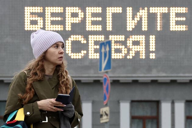 MOSCOW, RUSSIA - OCTOBER 29, 2021: A woman is seen by the Khudozhestvenny Cinema. Moscow has announced non-working days from October 28 to November 7 to prevent the spread of the novel coronavirus. Moscow restaurants and cafes are open for delivery and takeout during the period of non-working days. A sign reads Stay Safe! Valery Sharifulin TASS  TS116387