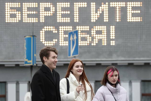 MOSCOW, RUSSIA - OCTOBER 29, 2021: People are seen by the Khudozhestvenny Cinema. Moscow has announced non-working days from October 28 to November 7 to prevent the spread of the novel coronavirus. Moscow restaurants and cafes are open for delivery and takeout during the period of non-working days. A sign reads Stay Safe! Valery Sharifulin TASS  TS116389