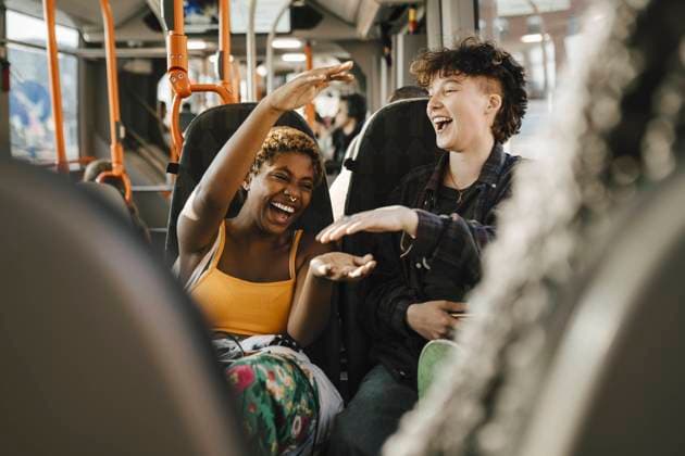 IMAGO Creative: Frauenmonat im März Cheerful multiracial friends traveling in bus Sweden, Malmo, model released Copyright: xMaskotx , MA89718