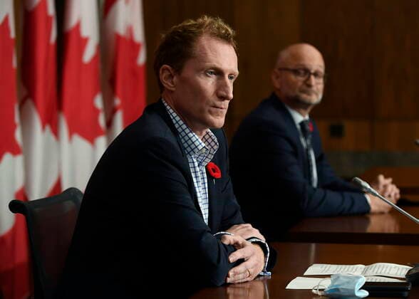 October 29, 2021, Ottawa, ON, CAN: Minister of Crown-Indigenous Relations Marc Miller, left, and Minister of Justice David Lametti listen during a news conference regarding the order from the Canadian Human Rights Tribunal to compensate Indigenous children and their families, in Ottawa, on Friday, Oct. 29, 2021. Ottawa CAN - ZUMAc35_ 20211029_zaf_c35_154 Copyright: xJustinxTangx