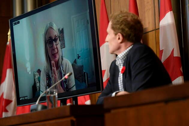 October 29, 2021, Ottawa, ON, CAN: Minister of Crown-Indigenous Relations Marc Miller, right, listens as Minister of Indigenous Services Patty Hajdu, appearing via video conference at left, participates in a news conference regarding the order from the Canadian Human Rights Tribunal to compensate Indigenous children and their families, in Ottawa, on Friday, Oct. 29, 2021. Ottawa CAN - ZUMAc35_ 20211029_zaf_c35_155 Copyright: xJustinxTangx