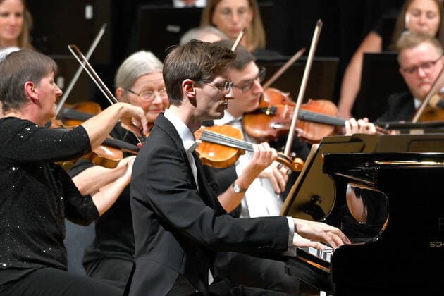 Concert of the orchestra of the Gesellschaft der Musikfreunde Gmunden, at the Toskana Kongress, as part of the Salzkammergut Festwochen in Gmunden, on 30 10 21 The picture shows the pianist Florian Feilmair playing, with violinists surrounding him 2021 Concert of the orchestra of the Gesellschaft der Musikfreunde Gmunden, at the Toskana Kongress, as par