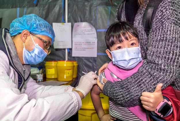 (211101) -- QIANXI, Nov. 1, 2021 -- A young student receives a dose of COVID-19 vaccine at a vaccination site in Qianxi City, southwest China s Guizhou Province, Nov. 1, 2021. Qianxi City on Monday launched a COVID-19 vaccination campaign for children aged 3 to 11. (Photo by Xinhua) CHINA-GUIZHOU-QIANXI-CHILDREN-COVID-19-VACCINATION (CN) FanxHui 