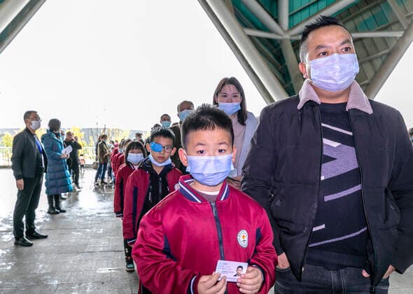 (211101) -- QIANXI, Nov. 1, 2021 -- Young students are accompanied by parents to receive COVID-19 vaccines at a vaccination site in Qianxi City, southwest China s Guizhou Province, Nov. 1, 2021. Qianxi City on Monday launched a COVID-19 vaccination campaign for children aged 3 to 11. (Photo by Xinhua) CHINA-GUIZHOU-QIANXI-CHILDREN-COVID-19-VACCINATION (CN) FanxHui 