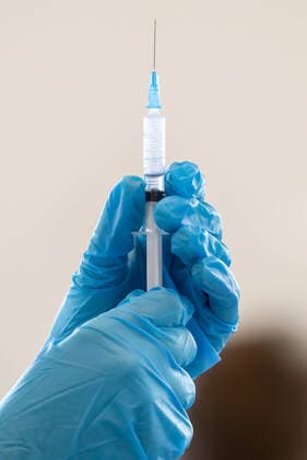 MOSCOW, RUSSIA â€“ NOVEMBER 1, 2021: A healthcare worker holds a syringe with a vaccine at a COVID-19 mobile vaccination site at the GUM department store. From October 28 to November 7, the Moscow authorities have introduced paid non-working days to limit the spread of the novel coronavirus disease (COVID-19). Shopping malls, entertainment establishments, fitness centres and non-essential retail stores will suspend their operation and cafes and restaurants will only provide takeaway and food delivery services during this time. Sergei Fadeichev TASS  TS116704