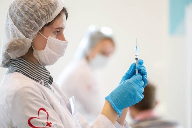 MOSCOW, RUSSIA â€“ NOVEMBER 1, 2021: A healthcare worker holds a syringe with a vaccine at a COVID-19 mobile vaccination site at the GUM department store. From October 28 to November 7, the Moscow authorities have introduced paid non-working days to limit the spread of the novel coronavirus disease (COVID-19). Shopping malls, entertainment establishments, fitness centres and non-essential retail stores will suspend their operation and cafes and restaurants will only provide takeaway and food delivery services during this time. Sergei Fadeichev TASS  TS116705