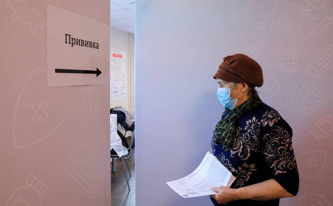 RYAZAN, RUSSIA - NOVEMBER 2, 2021: A woman prepares to receive a COVID-19 vaccine injection at the Single Vaccination Centre. It was opened by order of Ryazan Region Governor Lyubimov on November 1. Alexander Ryumin TASS  TS11694A