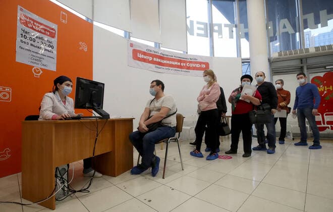 ST PETERSBURG, RUSSIA - NOVEMBER 8, 2021: People wait in line at a COVID-19 vaccination site at the Zanevsky Kaskad shopping mall. Alexander Demianchuk TASS  TS117146