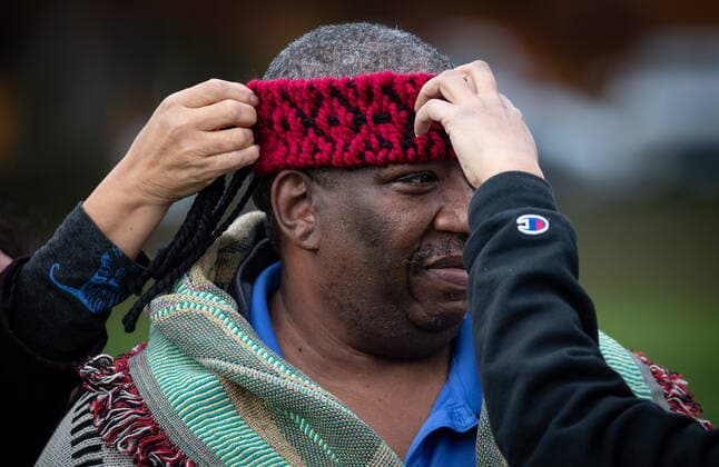 November 8, 2021, North Vancouver, BC, Canada: Dennis Owens, a U.S. Navy veteran from Kansas City who is married to Tsleil-Waututh Nation member Carol Thomas, has a headband placed on his head while being blanketed during a ceremony held by the First Nation to mark Indigenous Veterans Day, in North Vancouver, B.C., Monday, Nov. 8, 2021. Veterans Affairs Canada estimates that more than 12,000 First Nations, Inuit and Metis served during the First and Second World Wars and the Korean War. North Vancouver Canada - ZUMAc35_ 20211108_zaf_c35_112 Copyright: xDarrylxDyckx