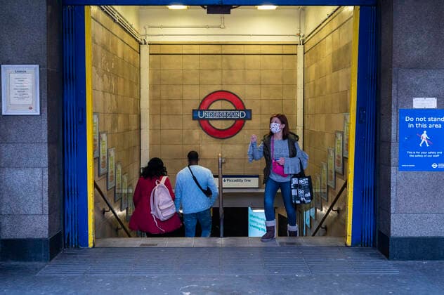 (211110) -- LONDON, Nov. 10, 2021 -- A woman wearing a mask exits a tube station in London, Britain, on Nov. 9, 2021. Britain on Tuesday registered 33,117 new COVID-19 infections and 262 coronavirus related deaths, bringing the total loss of lives to 142,124, according to the latest official figures. (Photo by Xinhua) BRITAIN-COVID-19-CASES StephenxChung 