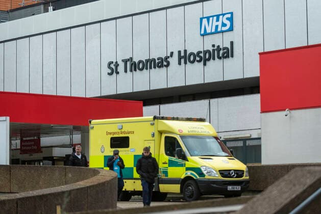 (211110) -- LONDON, Nov. 10, 2021 -- People pass an ambulance outside the emergency entrance at St Thomas Hospital in London, Britain, on Nov. 9, 2021. Britain on Tuesday registered 33,117 new COVID-19 infections and 262 coronavirus related deaths, bringing the total loss of lives to 142,124, according to the latest official figures. (Photo by Xinhua) BRITAIN-COVID-19-CASES StephenxChung 