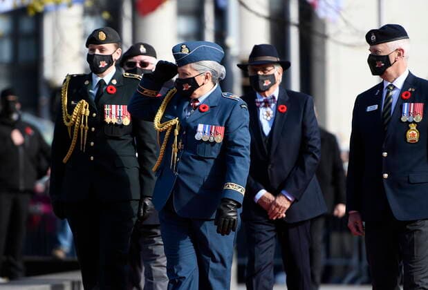November 11, 2021, Ottawa, ON, CAN: Gov. Gen. Mary Simon salutes as she arrives with her husband Whit Fraser, second from right, for the National Remembrance Day Ceremony at the National War Memorial in Ottawa, on Thursday, Nov. 11, 2021. Ottawa CAN  - ZUMAc35_ 20211111_zaf_c35_117 Copyright: xJustinxTangx