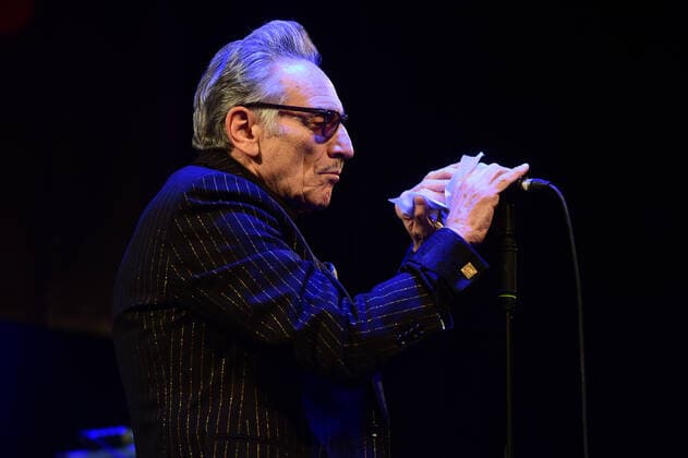 Singer Rick Estrin of Rick Estrin and The Nightcats music band disinfects the microphone before his performance during the 25th Blues Alive, blues & roots festival, on November 12, 2021, in Sumperk, Czech Republic. (CTKxPhoto LudekxPerina) CTKPhotoP2021111210529  LPE 034