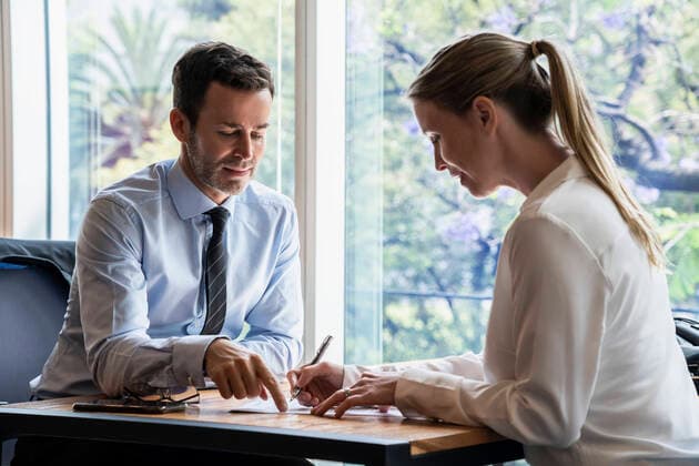 Businessman and businesswoman working in office Copyright: FrédéricxCirou B51710448
