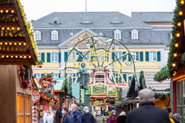 Bonn city center on 19 11 2021 people walk through the Bonn Christmas market Bonn city center North Rhine Westphalia Germany