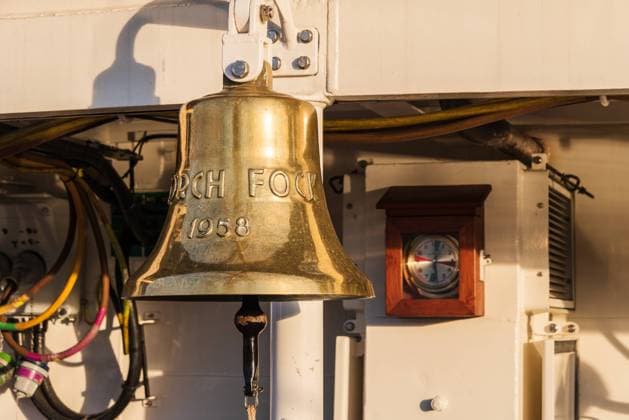 Bronzene Schiffsglocke des Segelschulschiffes Gorch Fock der Deutschen Marine im abendlichen Sonnenlicht *** Bronze ships bell of the sail training ship Gorch Fock of the German Navy in the evening sunlight