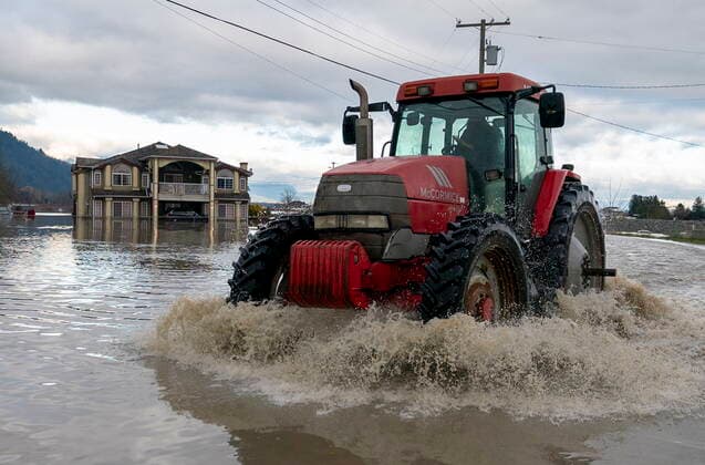November 19, 2021, ABBOTSFORD, BC, CANADA: A tractor drives over a flooded road caused by heavy rains and mudslides earlier in the week, in Abbotsford, B.C., Friday, November 19, 2021. ABBOTSFORD CANADA  - ZUMAc35_ 20211119_zaf_c35_131 Copyright: xJonathanxHaywardx