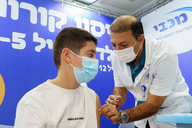 (211123) -- RAMAT HASHARON, Nov. 23, 2021 -- A child receives COVID-19 vaccine at a vaccination site in Ramat Hasharon, Israel, Nov. 22, 2021. Israel on Monday launched a COVID-19 vaccination campaign for children aged 5 to 11, Israel s health maintenance organizations (HMOs) said. ( via Xinhua) ISRAEL-RAMAT HASHARON-COVID-19-VACCINATION-CHILDREN JINI 