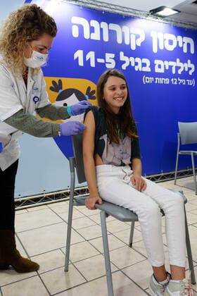 (211123) -- RAMAT HASHARON, Nov. 23, 2021 -- A child receives COVID-19 vaccine at a vaccination site in Ramat Hasharon, Israel, Nov. 22, 2021. Israel on Monday launched a COVID-19 vaccination campaign for children aged 5 to 11, Israel s health maintenance organizations (HMOs) said. ( via Xinhua) ISRAEL-RAMAT HASHARON-COVID-19-VACCINATION-CHILDREN JINI 