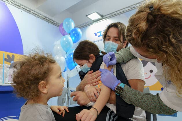 (211123) -- RAMAT HASHARON, Nov. 23, 2021 -- A child receives COVID-19 vaccine at a vaccination site in Ramat Hasharon, Israel, Nov. 22, 2021. Israel on Monday launched a COVID-19 vaccination campaign for children aged 5 to 11, Israel s health maintenance organizations (HMOs) said. ( via Xinhua) ISRAEL-RAMAT HASHARON-COVID-19-VACCINATION-CHILDREN JINI 
