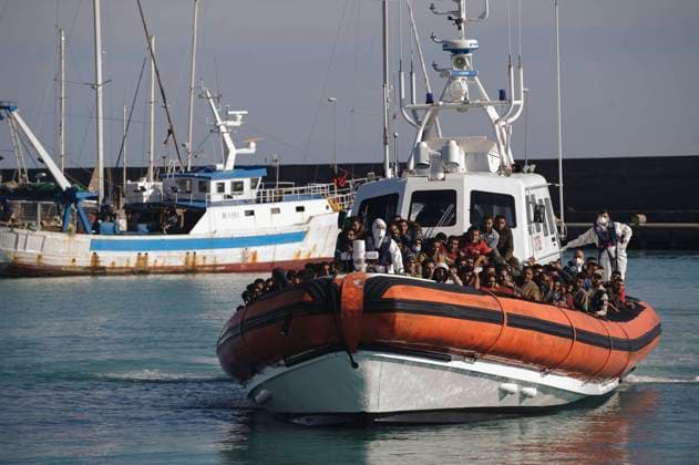 November 14, 2021, Roccella Jonica, Calabria, Italy: Migrants seen arriving on a patrol boat at the seaport of Roccella Jonica..More than 500 migrants, mostly from Egypt, who were sailing through rough waters of the Mediterranean Sea in moments of a strong storm, have been rescued near Roccella Jonica, in Southern Italy. The migrants were taken to the seaport of Roccella Jonica and provided with sanitary assistance and care by volunteers of the Red Cross and Civil Protection. Roccella Jonica Italy - ZUMAs197 20211114_zaa_s197_391 Copyright: xValeriaxFerrarox