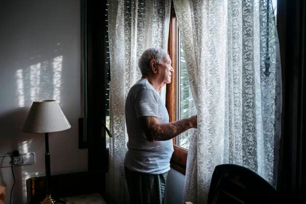 Man looking through window at home model released property released, JRFF05188