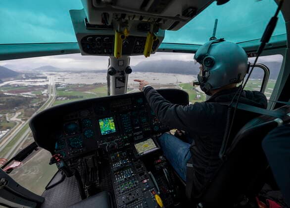 November 23, 2021, ABBOTSFORD, BC, CANADA: Helicopter pilot Kelsey Wheeler flies over the flood damage in Abbotsford, B.C., Tuesday, November 23, 2021. ABBOTSFORD CANADA  - ZUMAc35_ 20211123_zaf_c35_162 Copyright: xJonathanxHaywardx