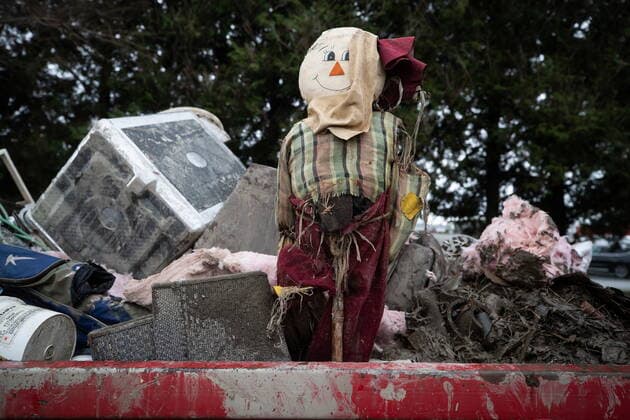November 23, 2021, Abbotsford, Canada: A scarecrow sits in a dumpster along with other items disposed of by Bruce Kirichenko from his flooded house on a farm after floodwaters receded in the area on Tuesda. He said water filled his basement and was within inches of reaching the main floor floorboards. Abbotsford Canada  - ZUMAc35_ 20211123_zaf_c35_135 Copyright: xDarrylxDyckx