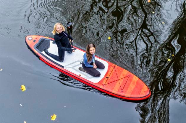 Friends enjoying paddleboarding on Rems river at Baden-Wurttemberg, Germany model released, STSF03108