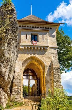 Ojcow, Poland - August 24, 2020: Gate tower and limestone rocky defense walls of medieval royal Ojcow Castle on Cracow-Czestochowa upland in Lesser Poland  BEW1DDB0A53