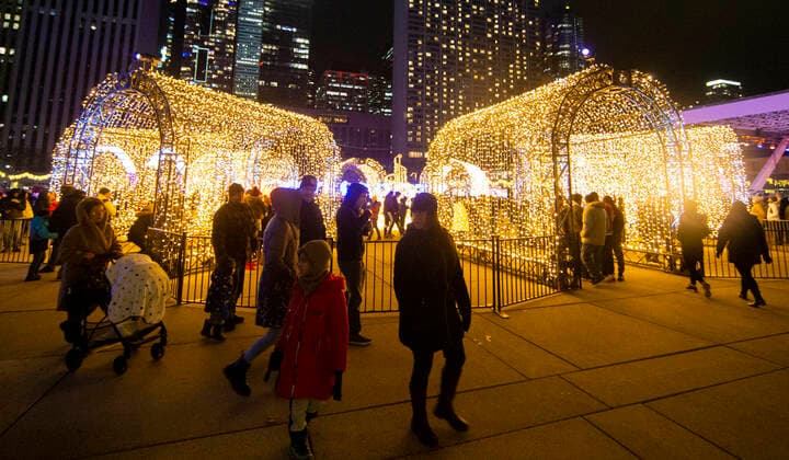(211128) -- TORONTO, Nov. 28, 2021 -- People visit the 2021 Cavalcade of Lights in Toronto, Canada, Nov. 27, 2021. The annual light show in Toronto kicked off on Saturday and will last until Jan. 2, 2022. (Photo by Xinhua) CANADA-TORONTO-LIGHT SHOW ZouxZheng 