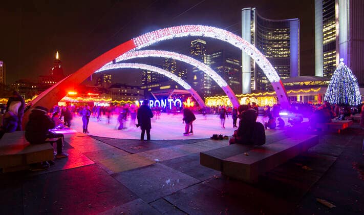 (211128) -- TORONTO, Nov. 28, 2021 -- People skate under a light installation during the 2021 Cavalcade of Lights in Toronto, Canada, Nov. 27, 2021. The annual light show in Toronto kicked off on Saturday and will last until Jan. 2, 2022. (Photo by Xinhua) CANADA-TORONTO-LIGHT SHOW ZouxZheng 