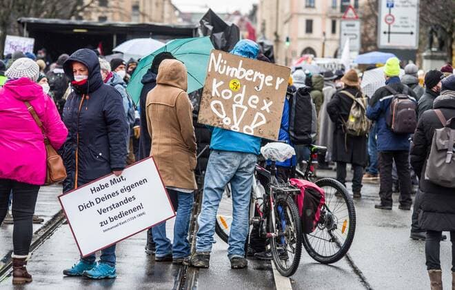 November 28, 2021, Munich, Bavaria, Germany: A sign with the words Nuremberg Code and Markus Soeder on it. The Nuremburg Codes is a beloved element of conspiracy theorists and QAnons where they believe physicians, researchers, and nurses should stand before tribunals and eventually executed for taking part in the Corona crisis and vaccinations. Despite southern Bavaria being in the clutches of a brutal fourth wave and beingnonnthe cusp of a Delta and Omicron Winter, Corona deniers from throughout Germany banded together without respecting any of the infection control regulations to memorialize disgraced former police officer and conspiracy theorist Karl Hilz who died after being reported by those in his circles as a pneumonia . Sin - ZUMAb160 20211128_zbp_b160_016 Copyright: xSachellexBabbarx
