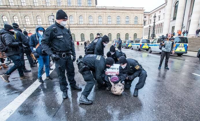 November 28, 2021, Munich, Bavaria, Germany: Munich police detain Corona deniers who refused to comply with requests to distance and wear masks. In numerous cases, the police were insulted and even appeared to have been assaulted. Despite southern Bavaria being in the clutches of a brutal fourth wave and beingnonnthe cusp of a Delta and Omicron Winter, Corona deniers from throughout Germany banded together without respecting any of the infection control regulations to memorialize disgraced former police officer and conspiracy theorist Karl Hilz who died after being reported by those in his circles as a pneumonia . Since Hilz s death, numerous grifters from the Querdenker scene with little to no connection to him have claimed knowing him - ZUMAb160 20211128_zbp_b160_032 Copyright: xSachellexBabbarx