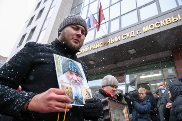 MOSCOW, RUSSIA - NOVEMBER 30, 2021: People gather outside Moscowâ€™s Izmailovsky District Court announcing the verdict to unordained schema hegumen Sergius (Nikolai Romanov), charged with unsanctioned actions, encouraging people to kill themselves, and violating the right for freedom of religion. Romanov was arrested at the Sredneuralsk Convent and sent to Moscow on December 29, 2020; he was excommunicated in May 2020 for violating a ban on preaching after calling on people to go to church despite the lockdown, describing the coronavirus situation as a fake pandemic . More recently, Sergius was stripped of his rank by the Yekaterinburg Eparchy court and ordered to leave the convent, but continued to perform church services nevertheless. The  TS11A0FC