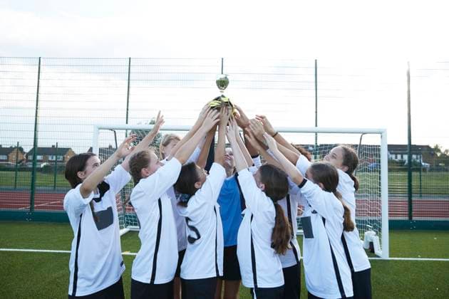 UK, Girls soccer teamÃä(10-11, 12-13)Ãäholding trophy in soccer field UK, Girls soccer teamÃä(10-11, 12-13)Ãäholding trophy in soccer field