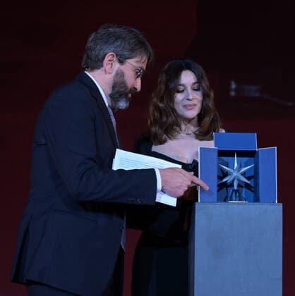 Turin, Monica Bellucci Stella della Mole award Turin Film Festival 2021 photocall with the presentation of the film THE GIRL THE FOUNTAIN by director Antongiulio Panizzi attended by Enzo Ghigo pres MNC, Domenico De Gaetano director MNC, In the photo: Monica Bellucci dress Dolce & Gabbana Cartier jewelry receives the award from Stefano Franncia di Celle artistic director of TFF  Copyright: xNickxZonnax xIPAx xNickxZonnax