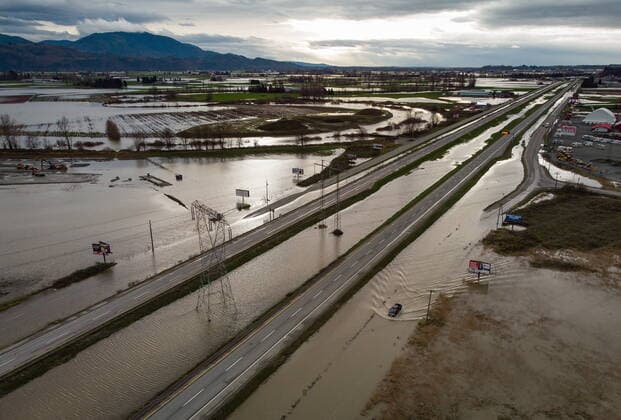 December 1, 2021, ABBOTSFORD, BC, CANADA: A motorist drives on a service road along the closed Trans-Canada Highway as floodwaters fill the ditches beside the highway and farmland in Abbotsford, B.C., on Wednesday, December 1, 2021. ABBOTSFORD CANADA  - ZUMAc35_ 20211201_zaf_c35_096 Copyright: xDarrylxDyckx